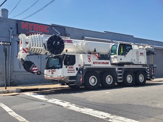 NYBSC-branded mobile crane outside a building in an archive photograph